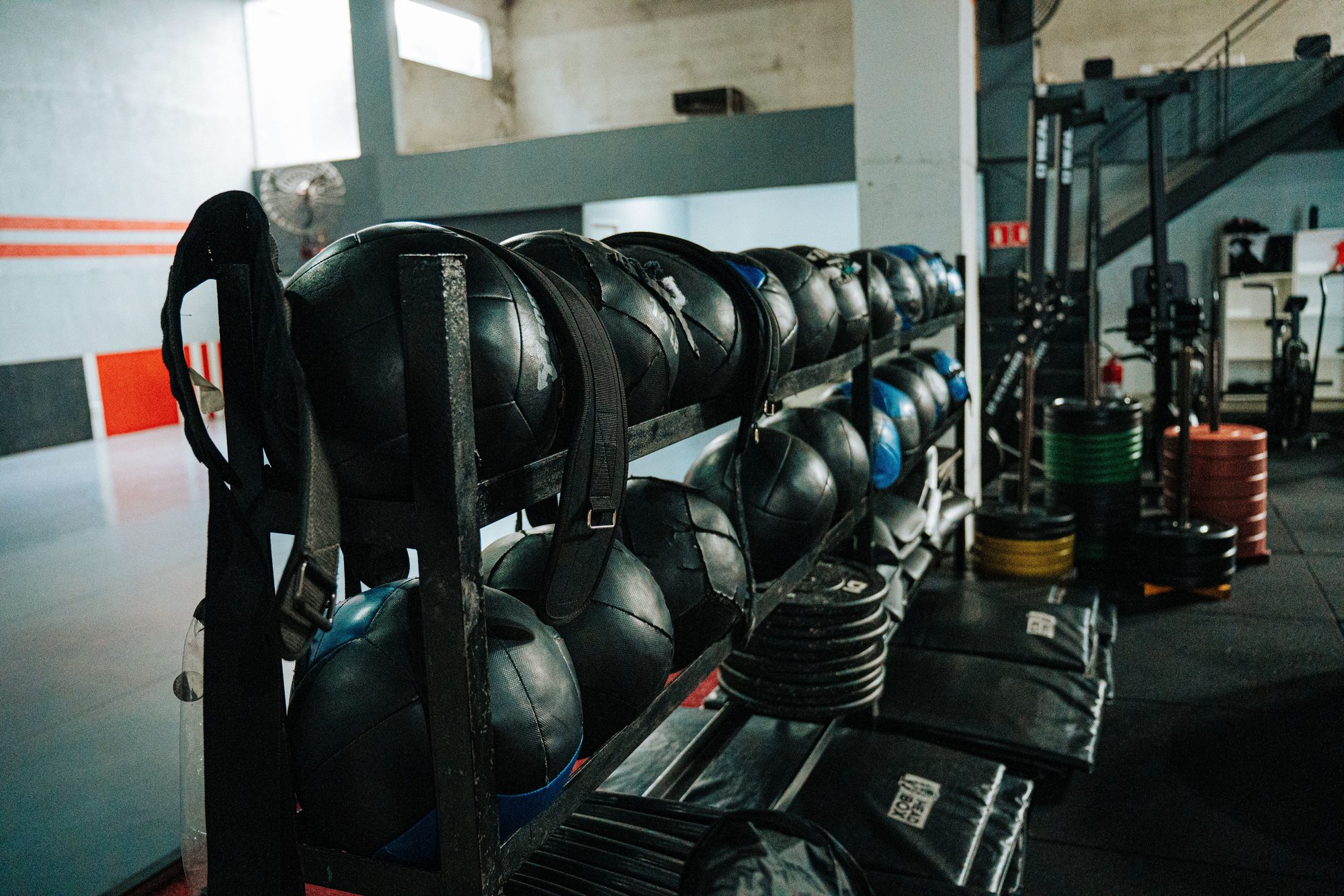 Rack of weighted slam balls lined up in the training area